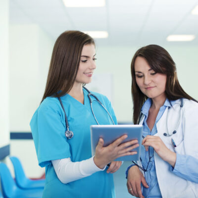 Female doctors checking results on digital tablet